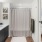 a bathroom with a bed and a mirror