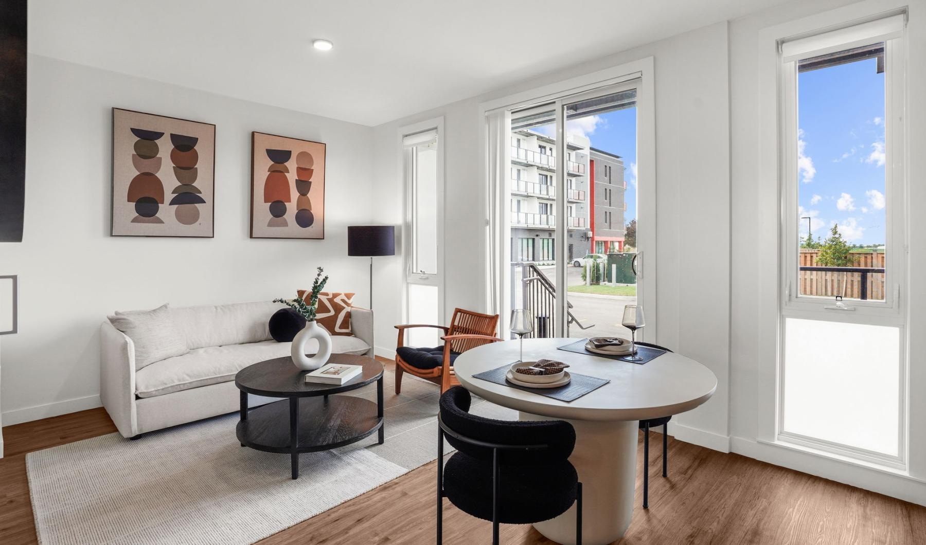 a living room with a table and chairs