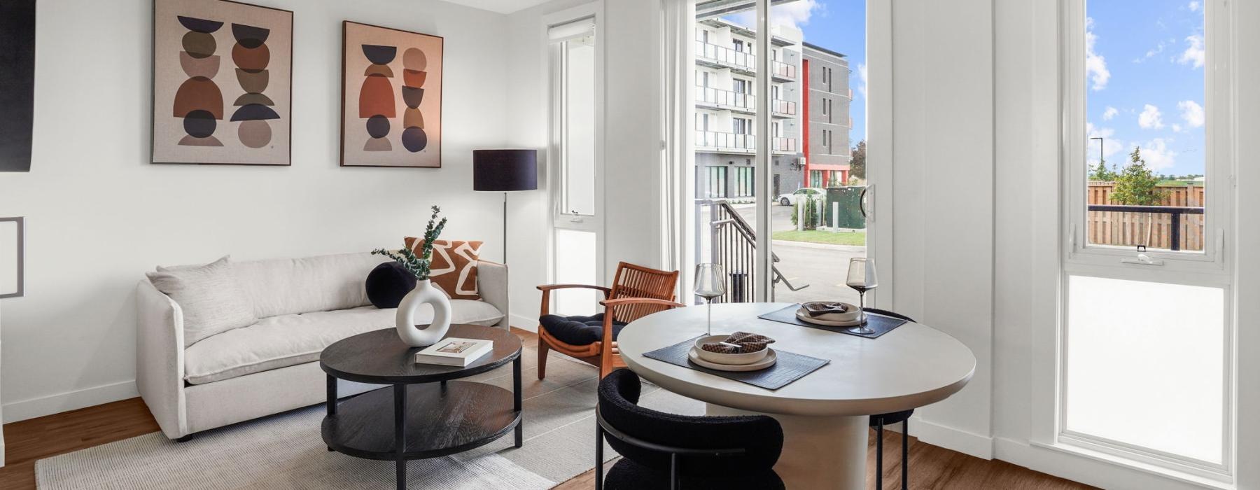 a living room with a table and chairs